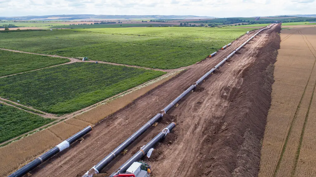 pipeline construction running through agricultural fields from aerial view